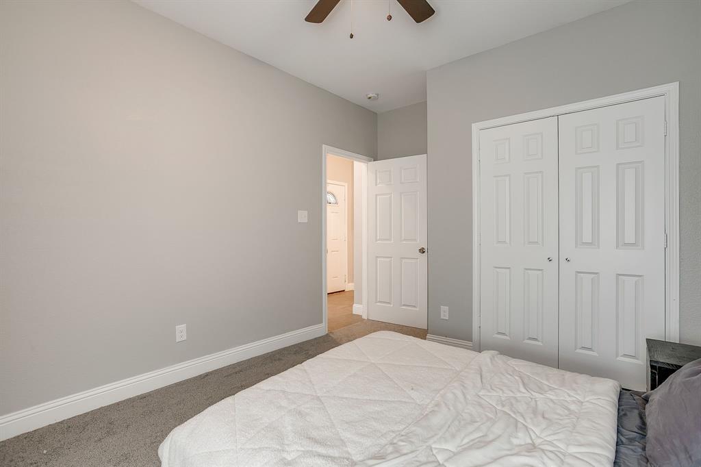 5617 Kilpatrick Avenue Fort Worth, TX 76107 - Photo 31 of 40 a bedroom with a bed and a chandelier