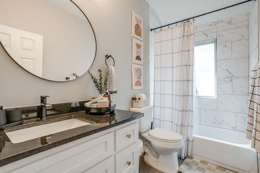 5617 Kilpatrick Avenue Fort Worth, TX 76107 - Photo 33 of 40 a bathroom with a sink a toilet and a mirror
