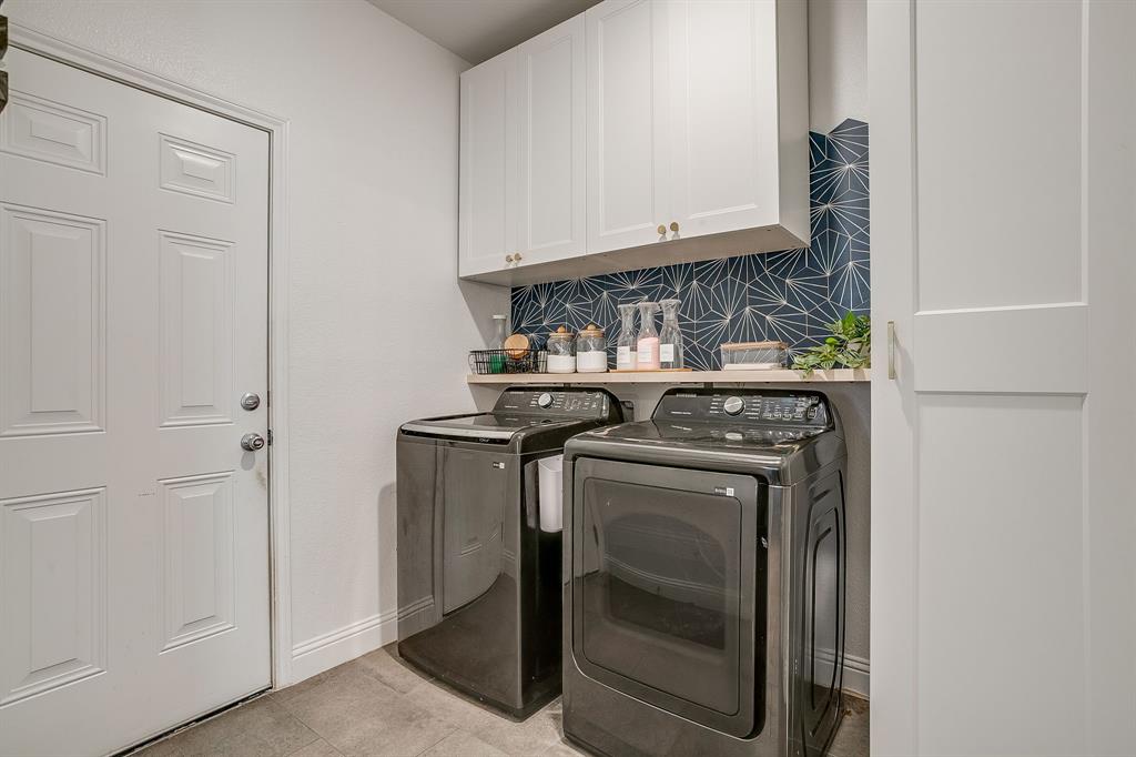 5617 Kilpatrick Avenue Fort Worth, TX 76107 - Photo 37 of 40 a view of washer and dryer with kitchen in the background