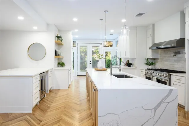 a kitchen with a sink stainless steel appliances and cabinets