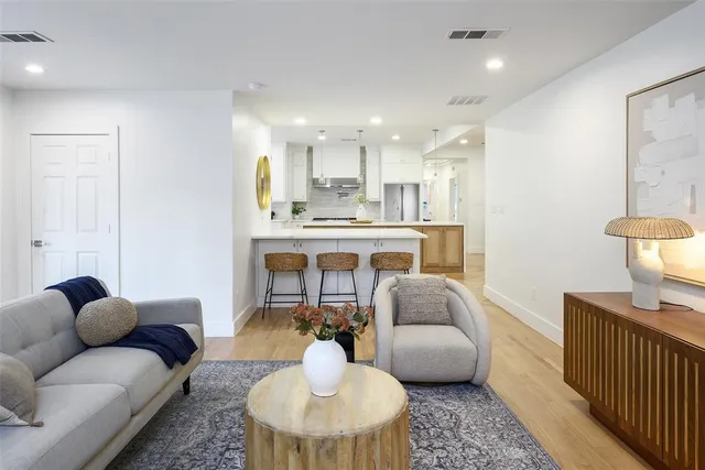 a living room with furniture and a chandelier