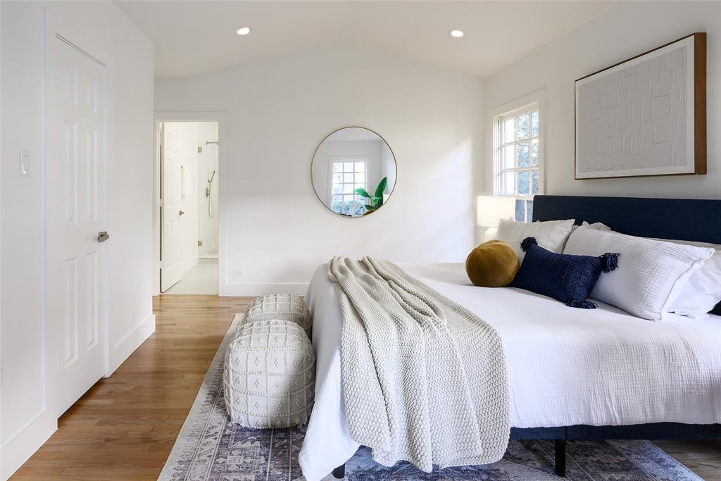 6021 Northwood Road Dallas, TX 75225 - Photo 25 of 40 a bedroom with bed and a night stand