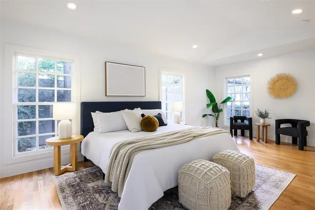 a bedroom with a bed and wooden floor