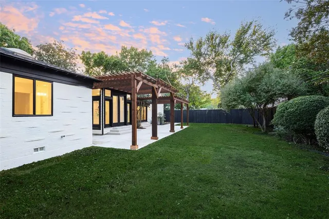 a view of house with backyard and garden