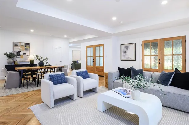 a living room with furniture and wooden floor