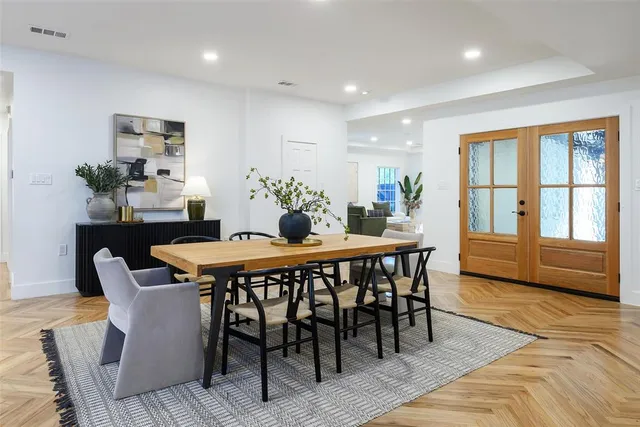 a dining room with furniture a rug and wooden floor