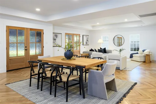 a living room with dining room and wooden floor