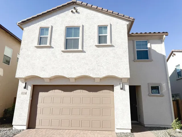 a view of a house with wooden fence