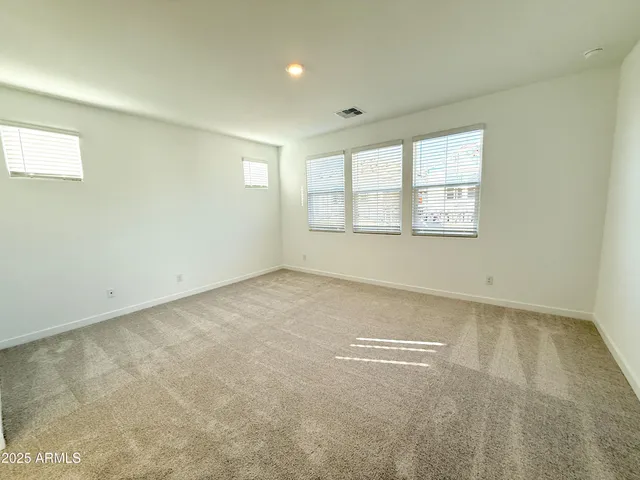 an empty room with a empty space and windows