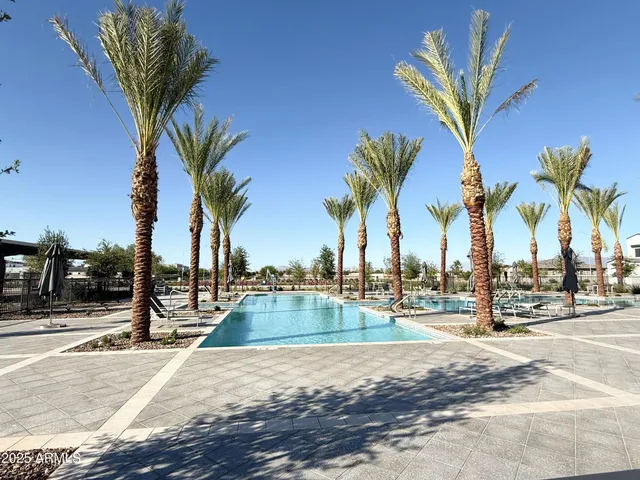 a view of a swimming pool with a table and chairs