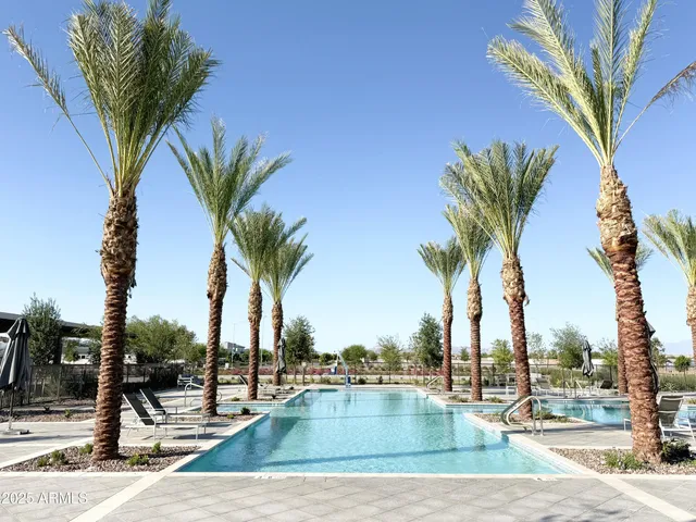 a view of multiple houses with swimming pool