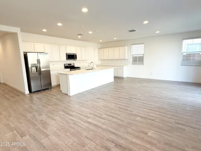 a view of kitchen with stainless steel appliances refrigerator microwave and stove