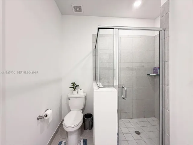 a view of a bedroom with furniture and windows