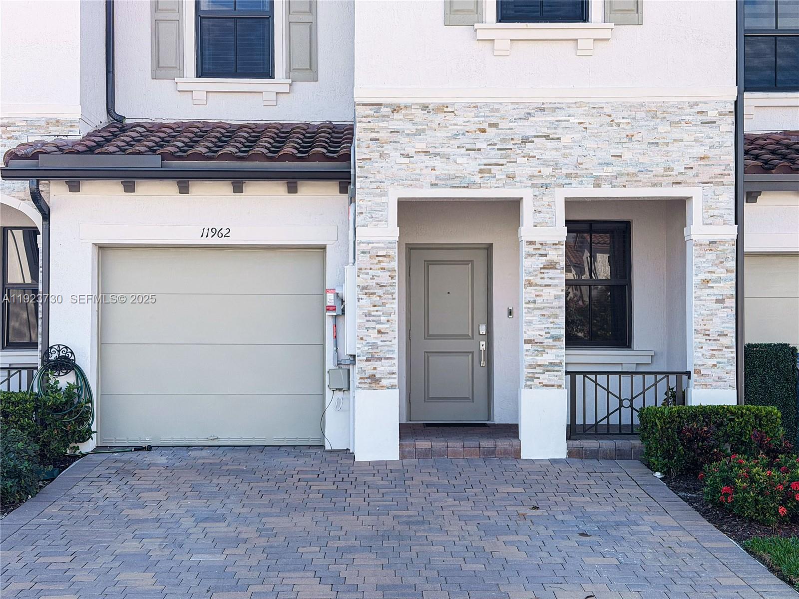 11962 Southwest 247th Terrace, Unit 11962 Homestead, FL 33032 - Photo 2 of 31 front view of a house with a yard