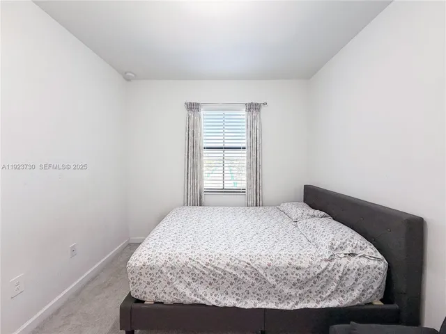 a bedroom with a bed and flat screen tv
