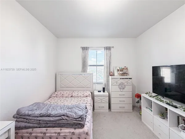 a white toilet sitting next to a shower