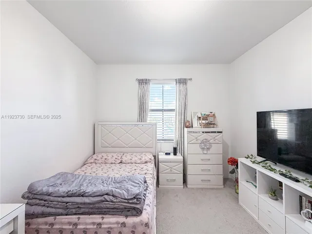 a white toilet sitting next to a shower