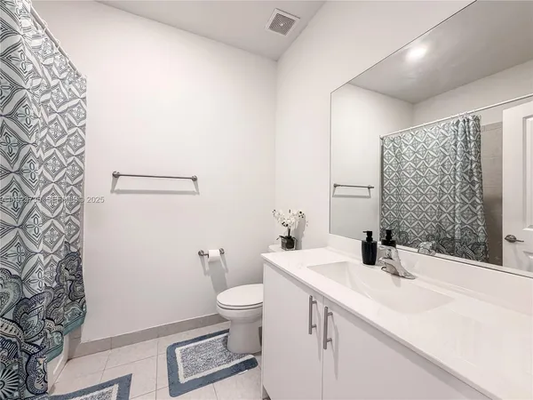 a bathroom with a sink a mirror and a shower