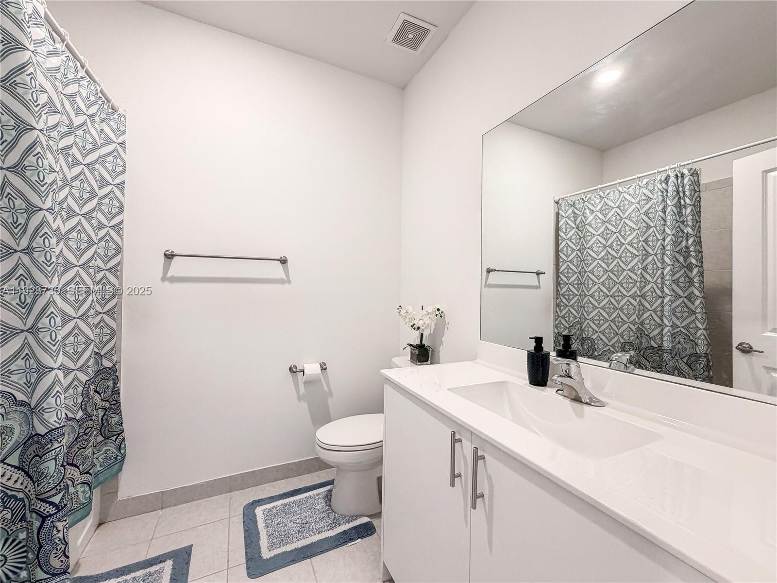 11962 Southwest 247th Terrace, Unit 11962 Homestead, FL 33032 - Photo 25 of 31 a bathroom with a sink and a toilet