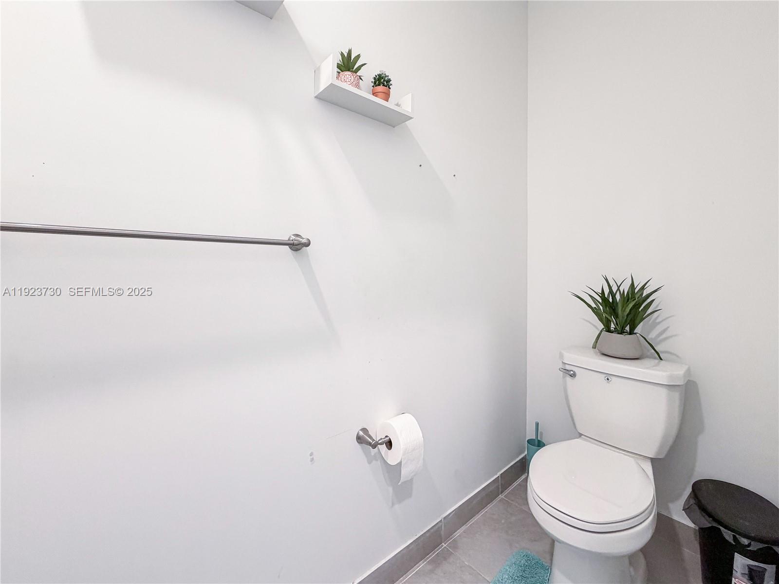 11962 Southwest 247th Terrace, Unit 11962 Homestead, FL 33032 - Photo 26 of 31 a white toilet sitting next to a shower