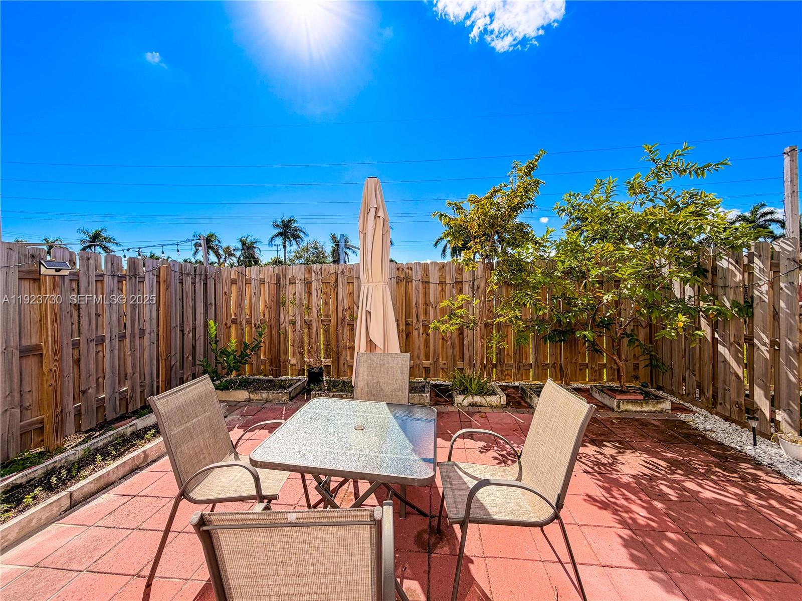 11962 Southwest 247th Terrace, Unit 11962 Homestead, FL 33032 - Photo 31 of 31 a view of a chairs and table in patio