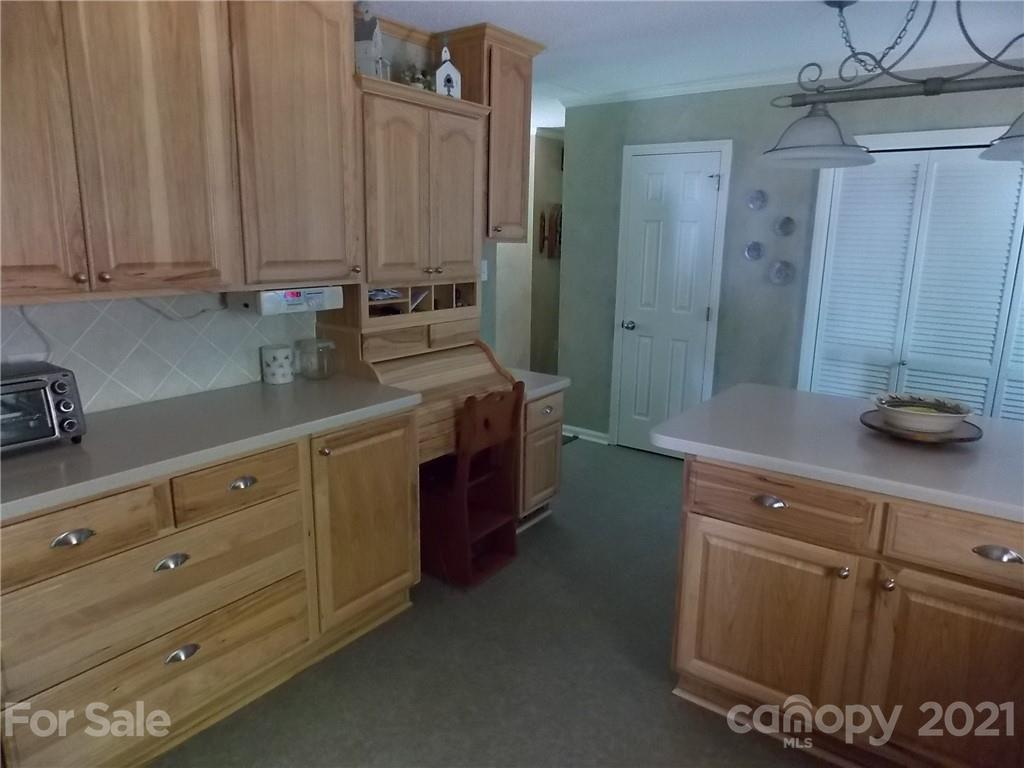 1766 Williams Road Fort Mill, SC 29715 - Photo 15 of 32 a kitchen with stainless steel appliances granite countertop a sink a stove and cabinets