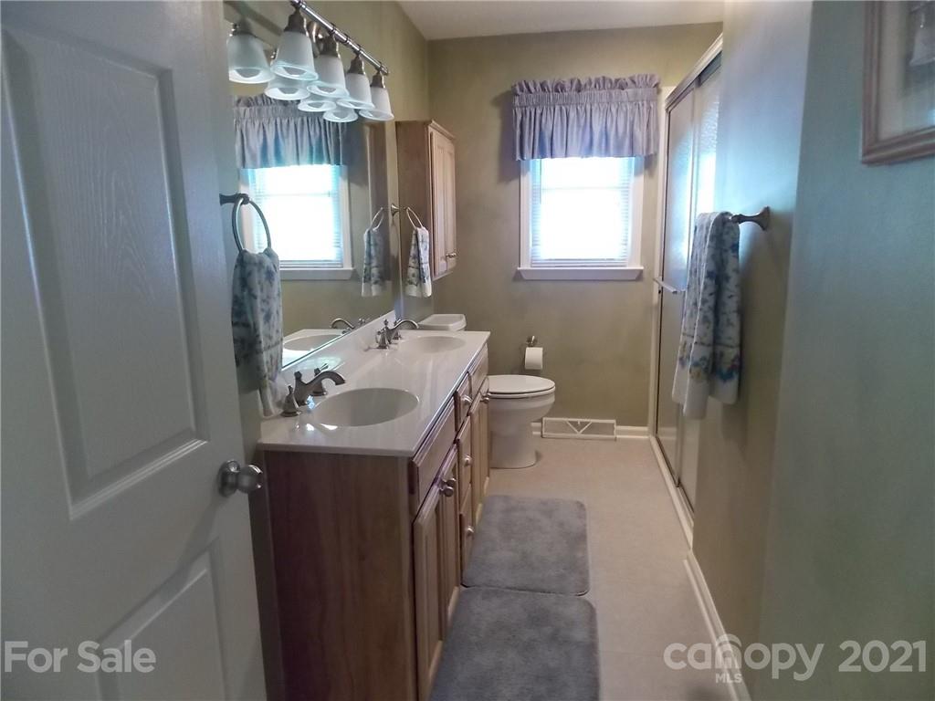 1766 Williams Road Fort Mill, SC 29715 - Photo 23 of 32 a bathroom with a sink a toilet and mirror