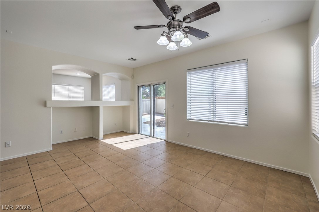 10939 Paradise Road Henderson, NV 89052 - Photo 14 of 36 A well-lit room featuring tile flooring and convenient sliding glass doors leading to the outdoors.