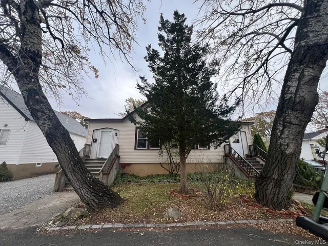 a view of a house with a tree in the background