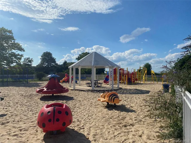 a backyard of a house with fire pit and outdoor seating