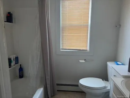 a white toilet sitting next to a bathroom sink