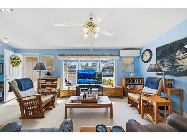 a living room with furniture and a large window