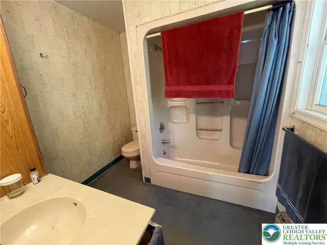 a bathroom with a bathtub and a sink