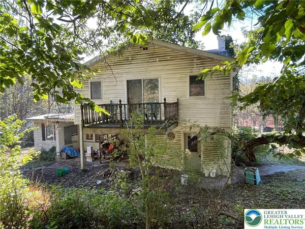 a view of a house with yard and sitting area