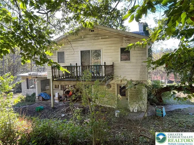 a view of a house with yard and sitting area