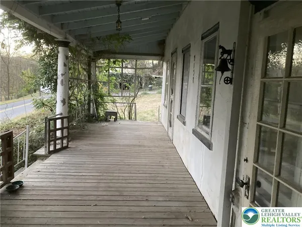 a view of a porch with wooden floor and outdoor space