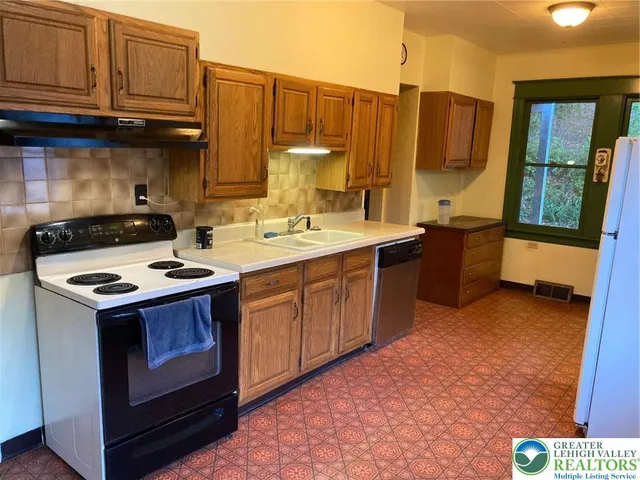 a kitchen with a sink stove and cabinets