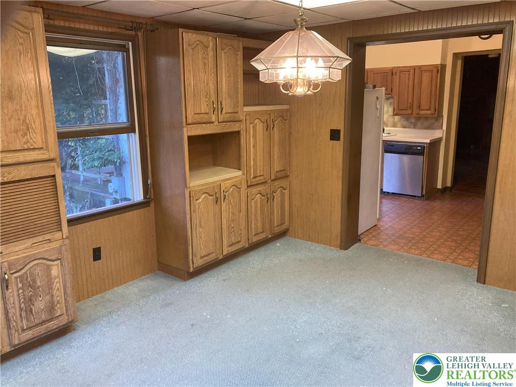 7007 Bausch Road New Tripoli, PA 18066 - Photo 10 of 36 a view of an empty room with a fireplace and a chandelier