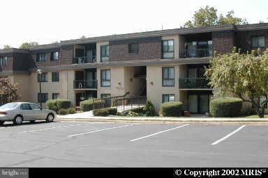 12712 Veirs Mill Road, Unit 843 Rockville, MD 20853 - Photo 1 of 10 a buildings with car parked in front of it