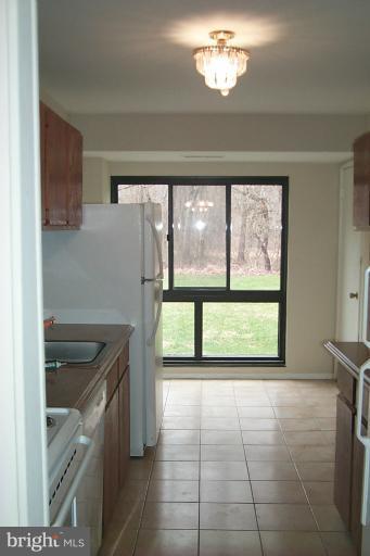12712 Veirs Mill Road, Unit 843 Rockville, MD 20853 - Photo 5 of 10 a kitchen that has a sink and a stove