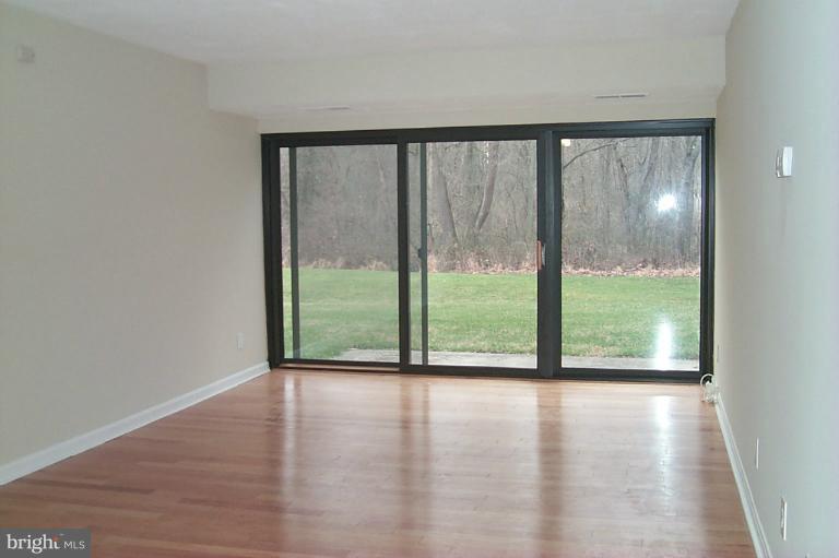 12712 Veirs Mill Road, Unit 843 Rockville, MD 20853 - Photo 9 of 10 a view of a big room with wooden floor and doors