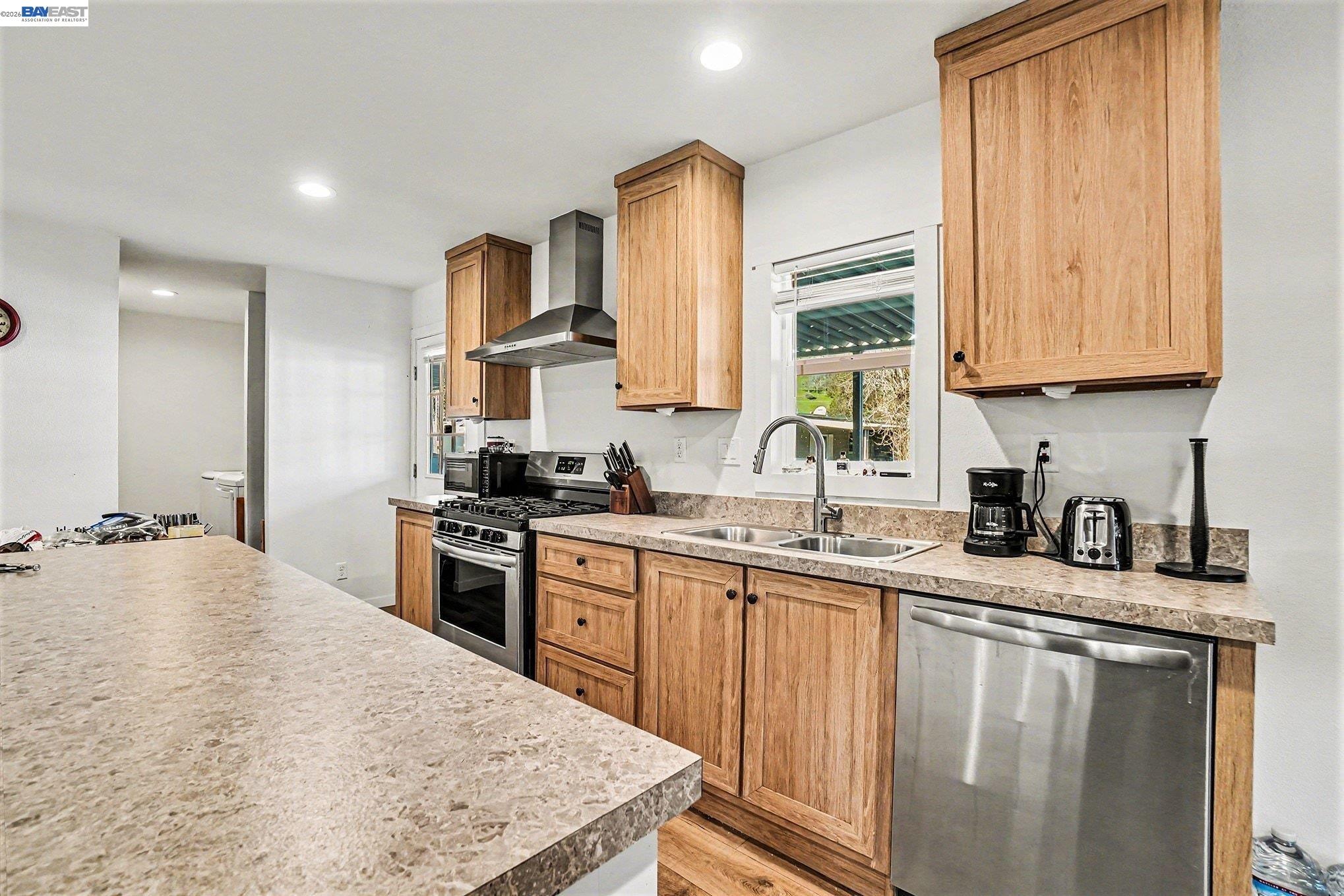 16711 Marsh Creek Road, Unit 150 Clayton, CA 94517 - Photo 3 of 19 a kitchen with stainless steel appliances granite countertop a sink stove refrigerator and cabinets