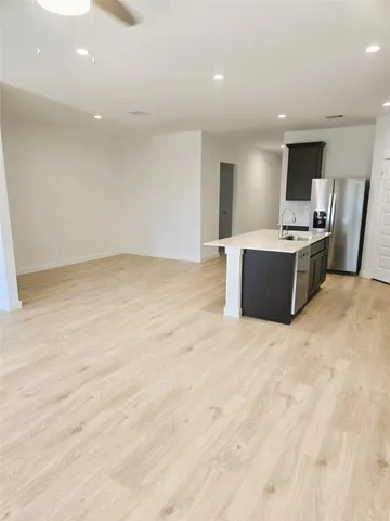 a view of kitchen with kitchen island wooden floor wooden floor and living room
