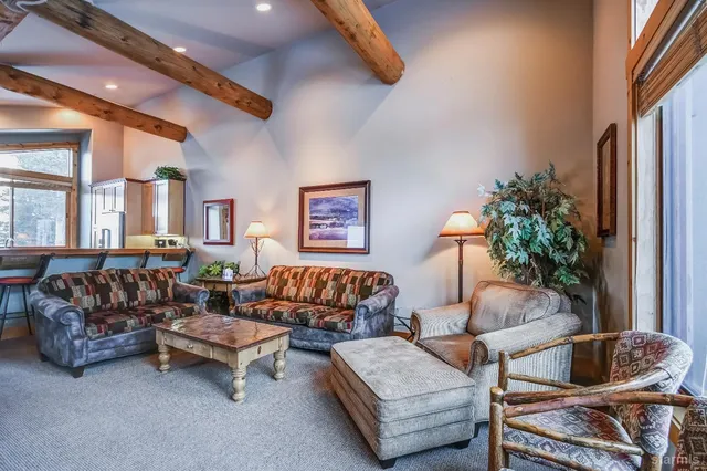 a living room with furniture ceiling fan and a window
