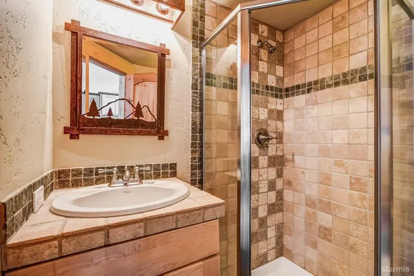 a bedroom with a bed and a lamp