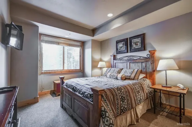a bedroom with a large bed and a dresser