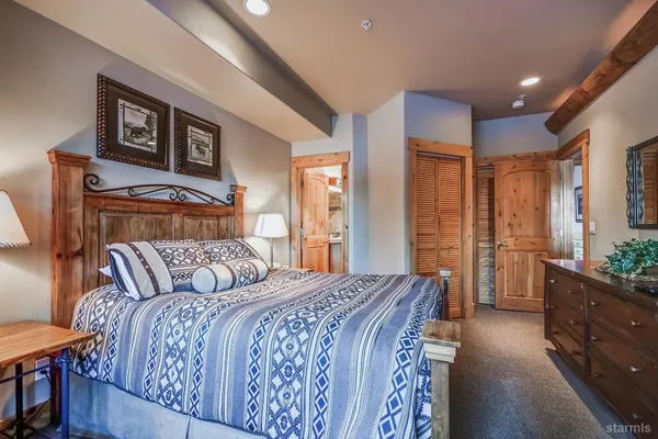 a bedroom with a bed and a lamp on table