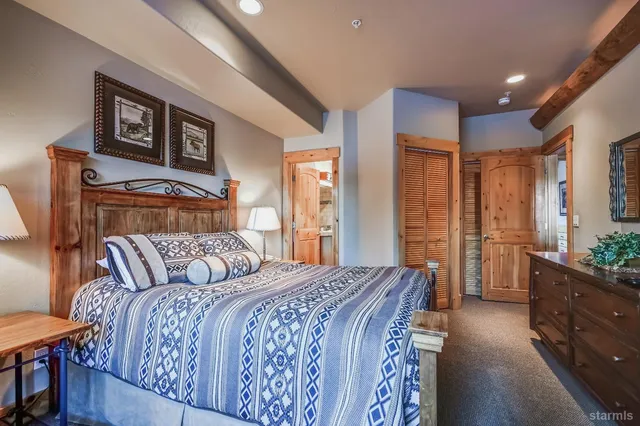 a bedroom with a bed and a lamp on table