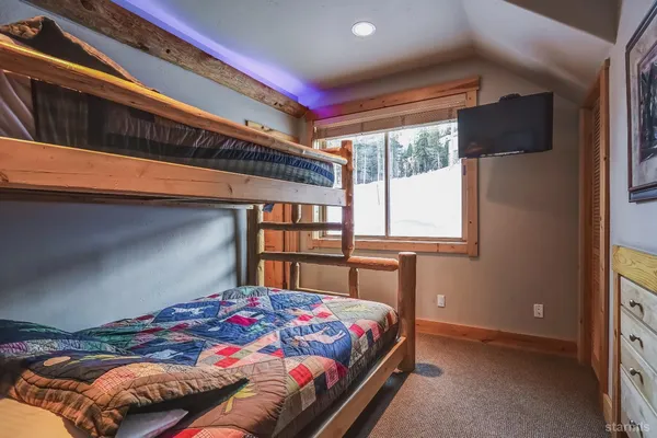 a bathroom with a sink shower and a mirror