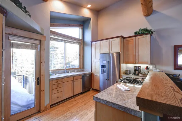 a view of a dining room with furniture a chandelier and wooden floor